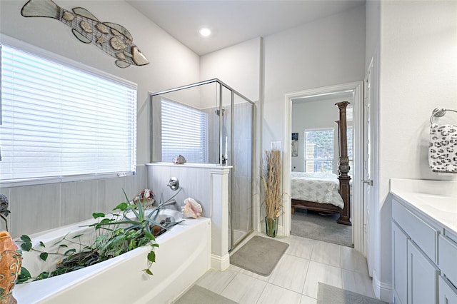 bathroom with tile patterned flooring, vanity, and independent shower and bath