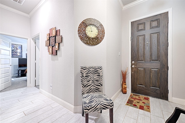 entryway with light wood-type flooring and crown molding