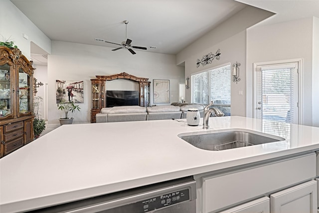 kitchen featuring white cabinetry, ceiling fan, sink, and stainless steel dishwasher