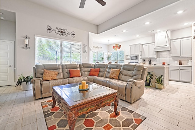 living room with ceiling fan and light hardwood / wood-style flooring