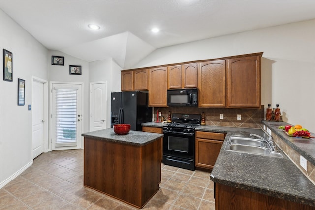 kitchen featuring a center island, black appliances, sink, vaulted ceiling, and tasteful backsplash