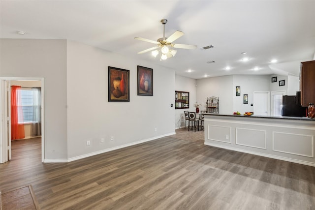 unfurnished living room featuring hardwood / wood-style floors and ceiling fan