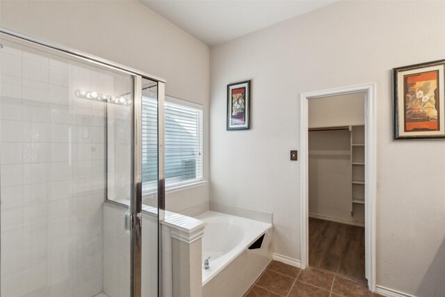 bathroom featuring plus walk in shower and tile patterned floors