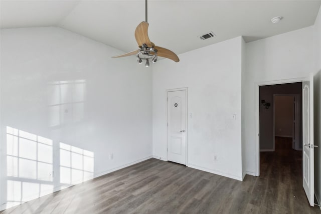 spare room featuring ceiling fan, dark wood-type flooring, and lofted ceiling