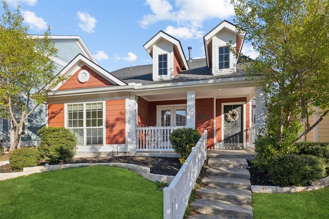 view of front of home with covered porch and a front yard