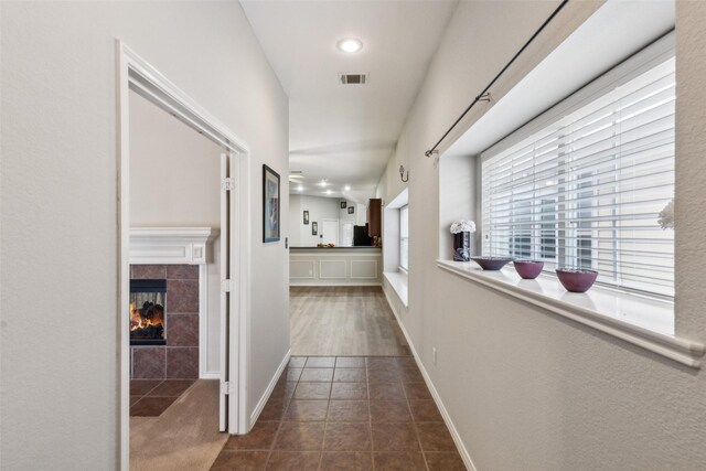 hallway with dark tile patterned flooring