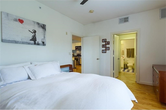 bedroom featuring ceiling fan, ensuite bathroom, and light hardwood / wood-style flooring