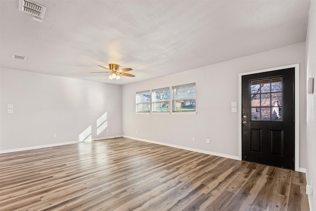 entryway with ceiling fan and wood-type flooring