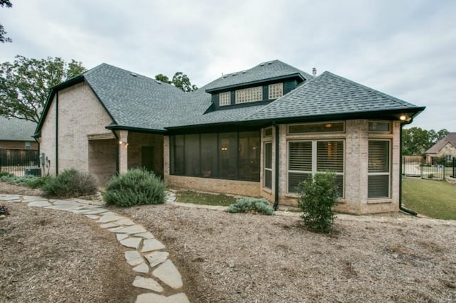 1218 Hunters Haven Dr, Kennedale, TX 76060 - view of front of home with roof with shingles, a sunroom, and brick siding