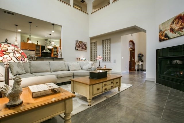 1218 Hunters Haven Dr, Kennedale, TX 76060 - living room with a high ceiling, arched walkways, and baseboards