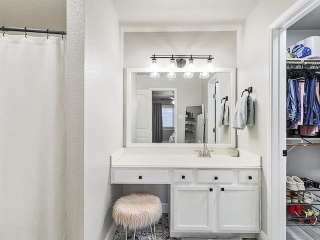 bathroom with curtained shower and vanity