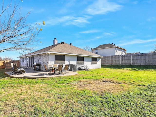 back of house with a yard and a patio area