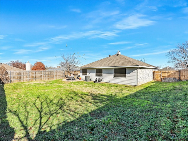 back of house featuring a lawn and a patio area