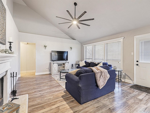 living room with ceiling fan, high vaulted ceiling, and light hardwood / wood-style flooring