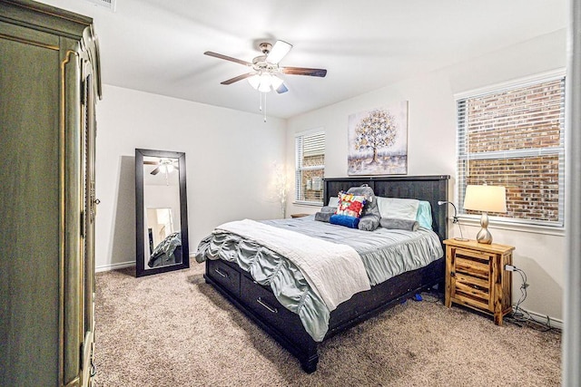 bedroom with ceiling fan and light carpet