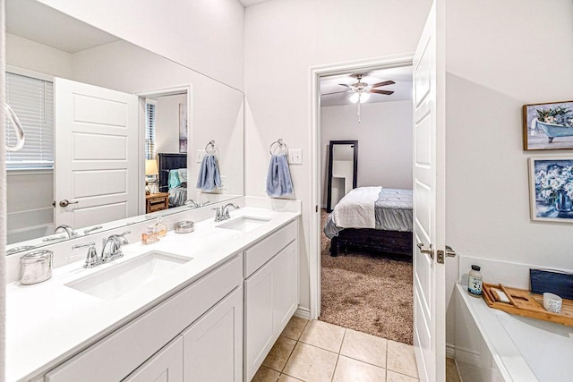 bathroom with tile patterned floors, vanity, and ceiling fan