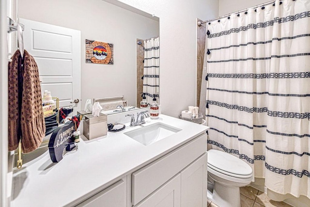 bathroom featuring tile patterned floors, walk in shower, vanity, and toilet