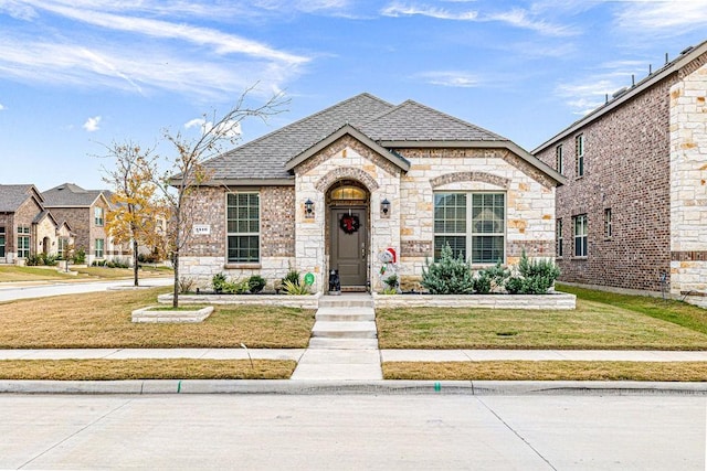 french country home with a front lawn