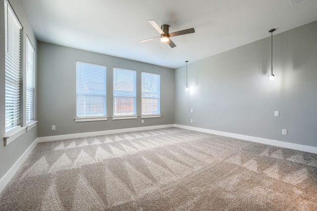 carpeted empty room featuring ceiling fan