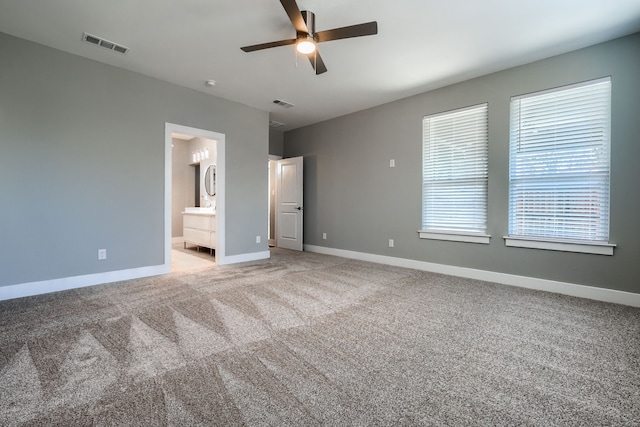 unfurnished bedroom with connected bathroom, ceiling fan, and carpet