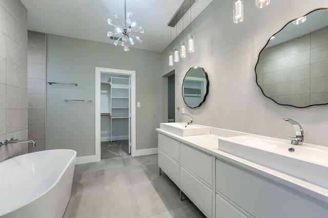 bathroom featuring vanity, a tub to relax in, and a chandelier