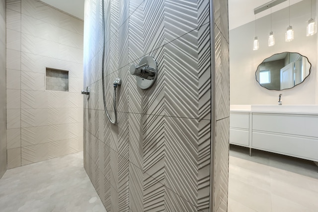 bathroom with vanity and tiled shower