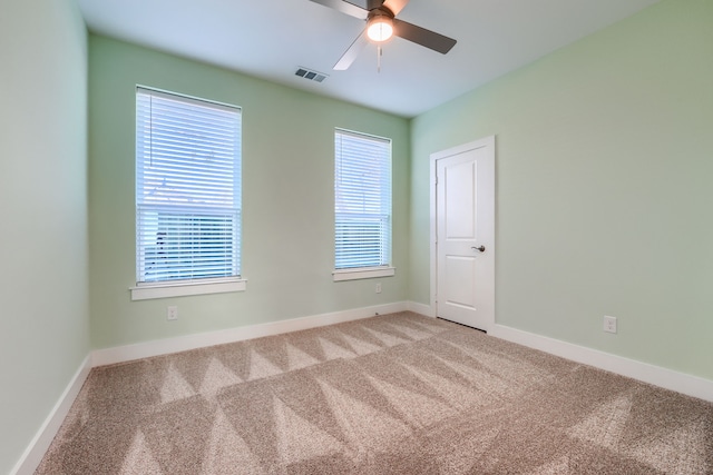 carpeted empty room featuring ceiling fan