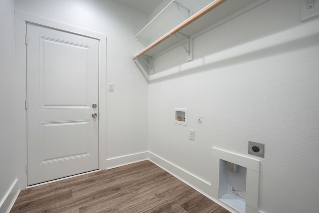 clothes washing area featuring wood-type flooring, hookup for a gas dryer, hookup for a washing machine, and electric dryer hookup