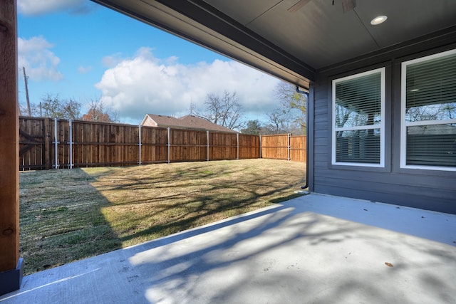 view of yard with a patio area and ceiling fan