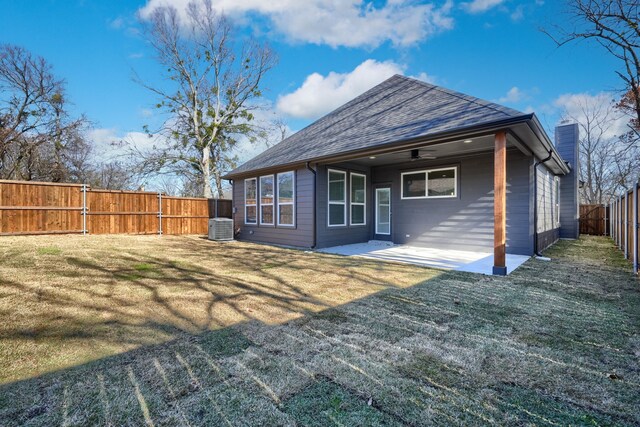 rear view of house featuring a lawn, central AC, and ceiling fan