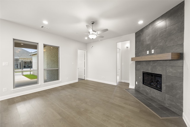 1402 Ethan Cir, Midlothian, TX 76065 - unfurnished living room featuring a ceiling fan, dark wood-type flooring, a tile fireplace, baseboards, and recessed lighting