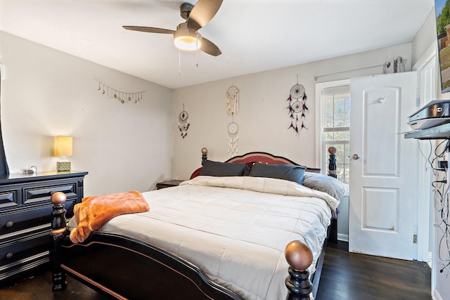 bedroom with dark hardwood / wood-style floors and ceiling fan