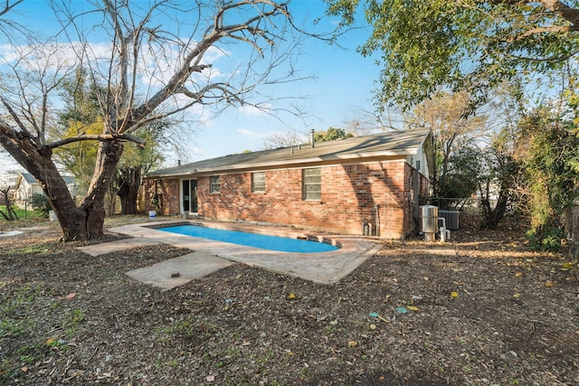 rear view of property featuring cooling unit and a patio area