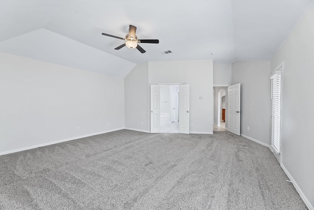 unfurnished bedroom featuring vaulted ceiling, ceiling fan, and carpet