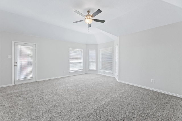 carpeted empty room featuring ceiling fan and vaulted ceiling