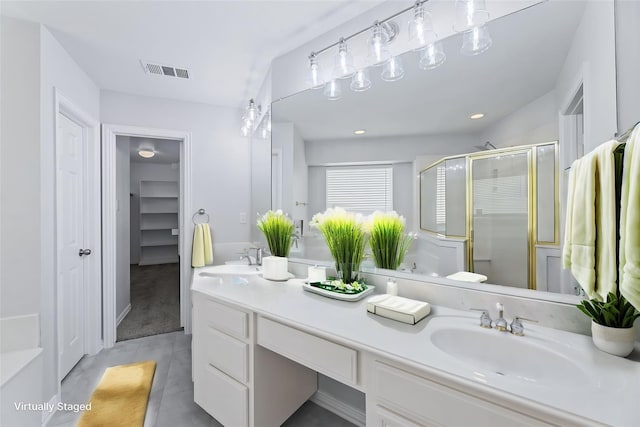 bathroom featuring an enclosed shower and vanity