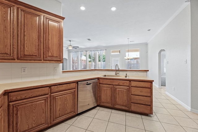 kitchen with kitchen peninsula, light tile patterned flooring, crown molding, stainless steel dishwasher, and sink