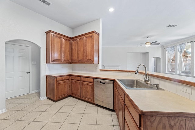 kitchen featuring light tile patterned floors, kitchen peninsula, tasteful backsplash, dishwasher, and sink