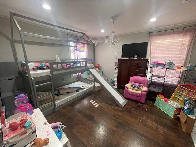 bedroom featuring dark hardwood / wood-style floors and an inviting chandelier