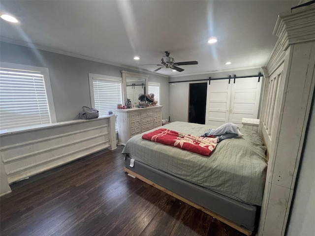 bedroom with dark wood-type flooring, ceiling fan, ornamental molding, and a barn door