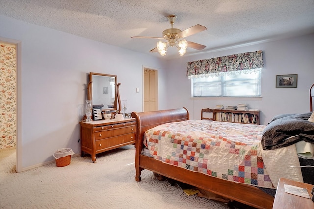 bedroom featuring ceiling fan, light carpet, and a textured ceiling