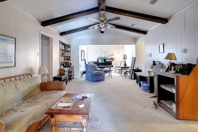 carpeted living room with ceiling fan, vaulted ceiling with beams, and a textured ceiling