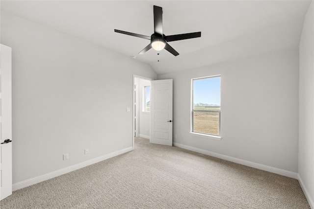 unfurnished room featuring lofted ceiling, carpet flooring, and ceiling fan