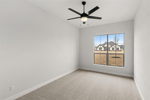 carpeted spare room with ceiling fan