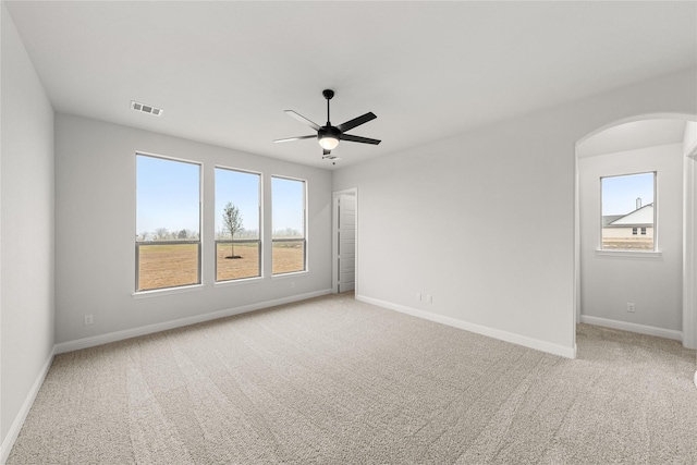 spare room featuring ceiling fan and light colored carpet