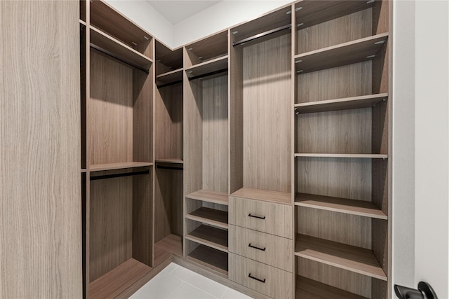 spacious closet featuring light tile patterned flooring