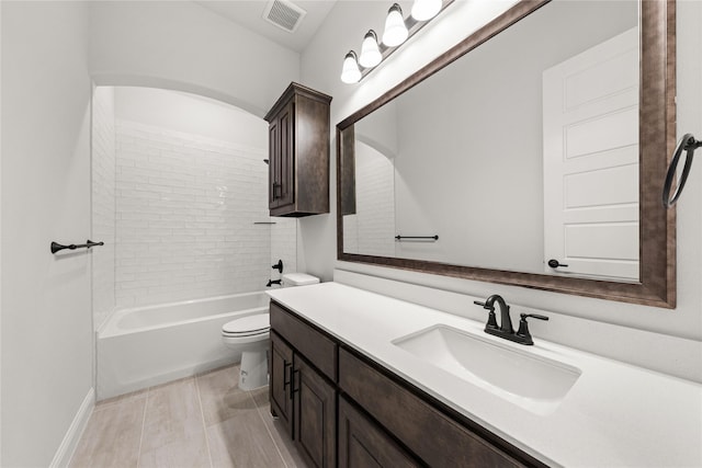 full bathroom featuring vanity, tiled shower / bath combo, and toilet