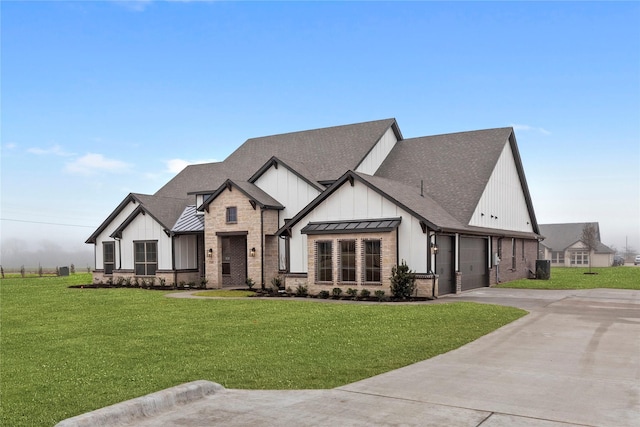 modern inspired farmhouse with a garage and a front yard