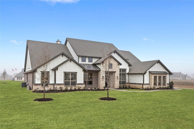 view of front of house featuring a front yard and central air condition unit