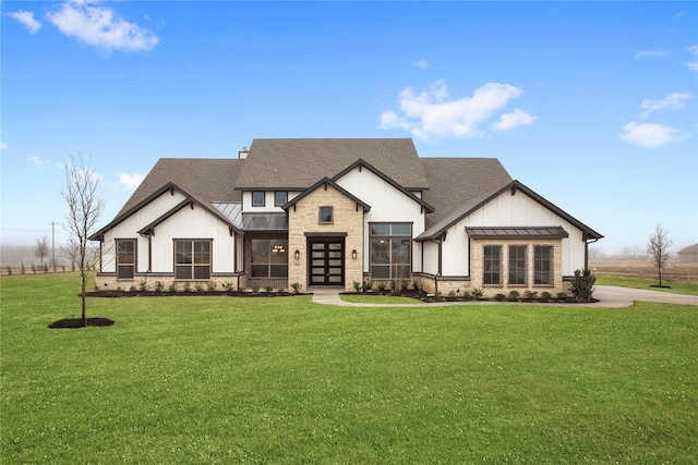 modern farmhouse with a front lawn and french doors